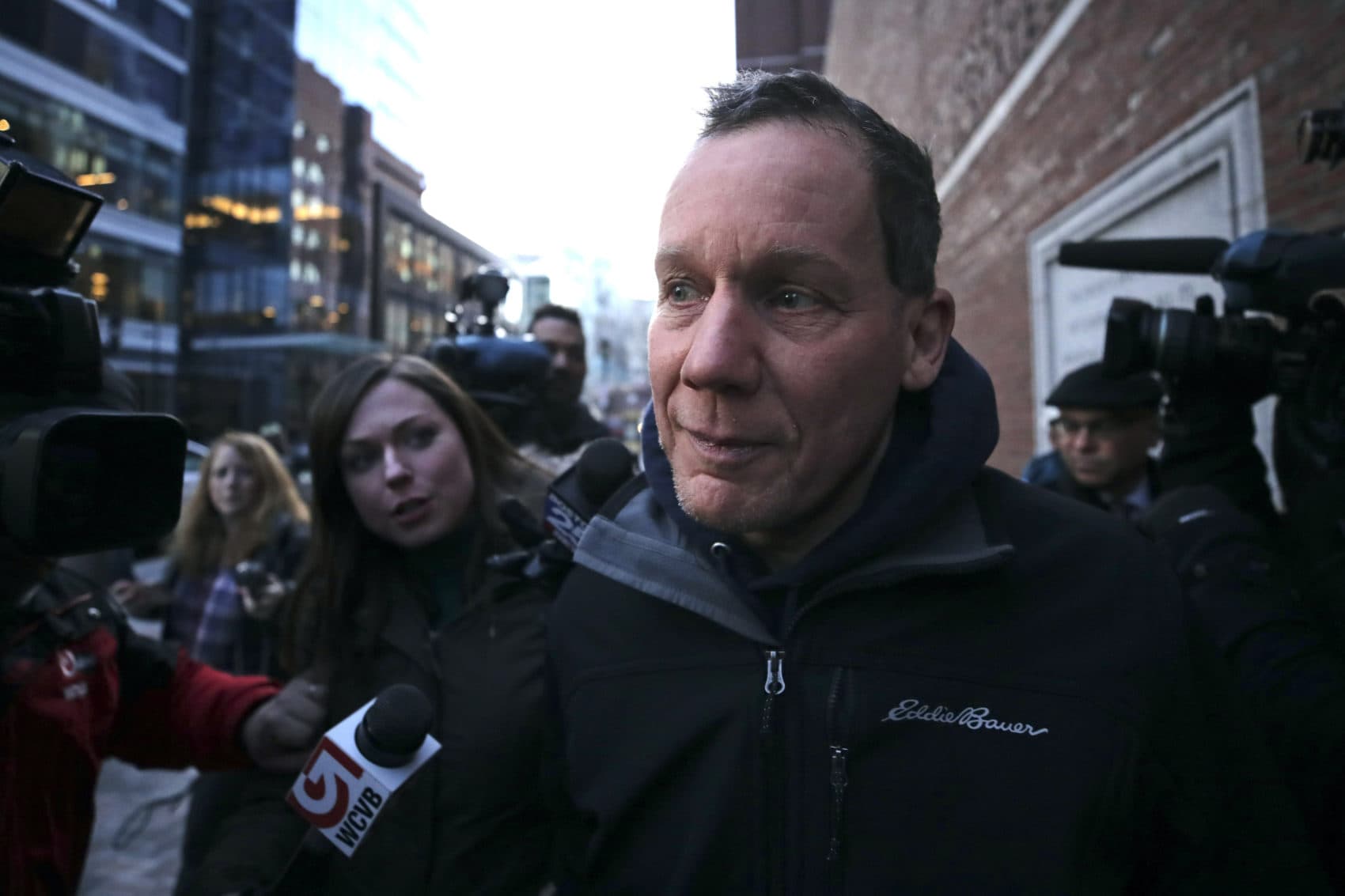 Harvard University professor Charles Lieber is surrounded by reporters as he leaves the Moakley Federal Courthouse in Boston Thursday. (Charles Krupa/AP)