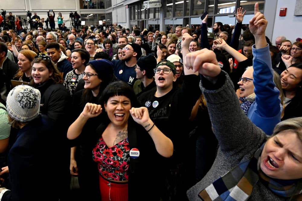 Monica Rey 32, (center), Gina Christo 27, (right) and Anne Rousseau 63, (far right) all of Boston sing "Sweet Caroline" at the Manchester Canvass Kickoff for Elizabeth Warren at Manchester Community College Saturday. (Joe Amon/Connecticut Public/NENC)