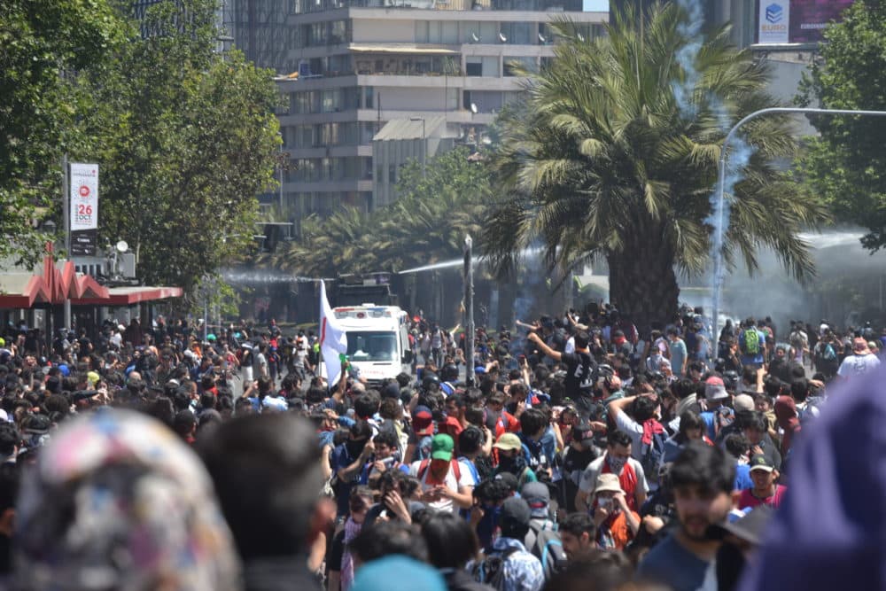 The crowd hit the streets to protest against Santiago's metro fare increase. (Paige Sutherland)