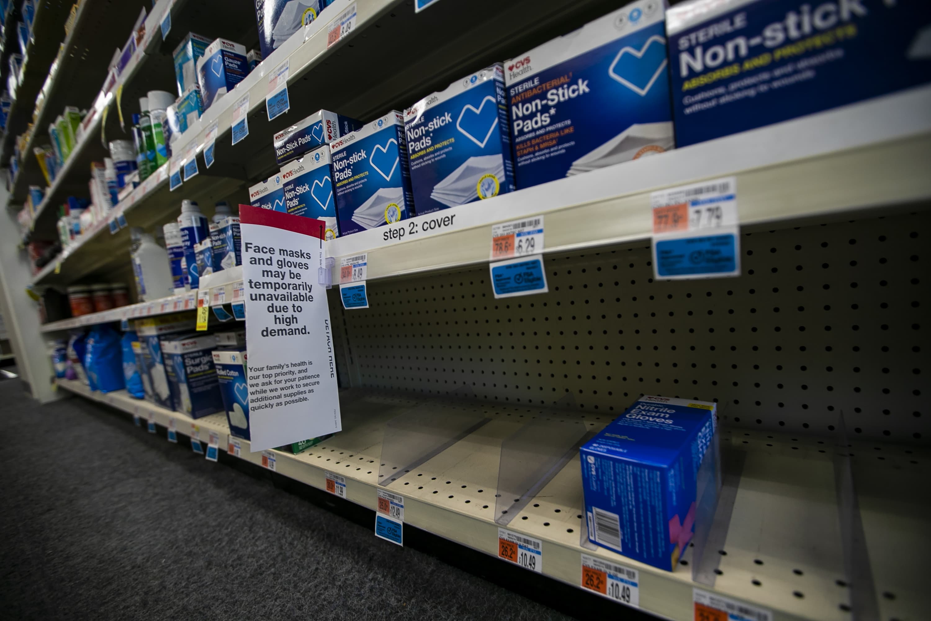 Shelves at the CVS Pharmacy on Commonwealth Ave. are temporarily empty of face masks and gloves. (Jesse Costa/WBUR)