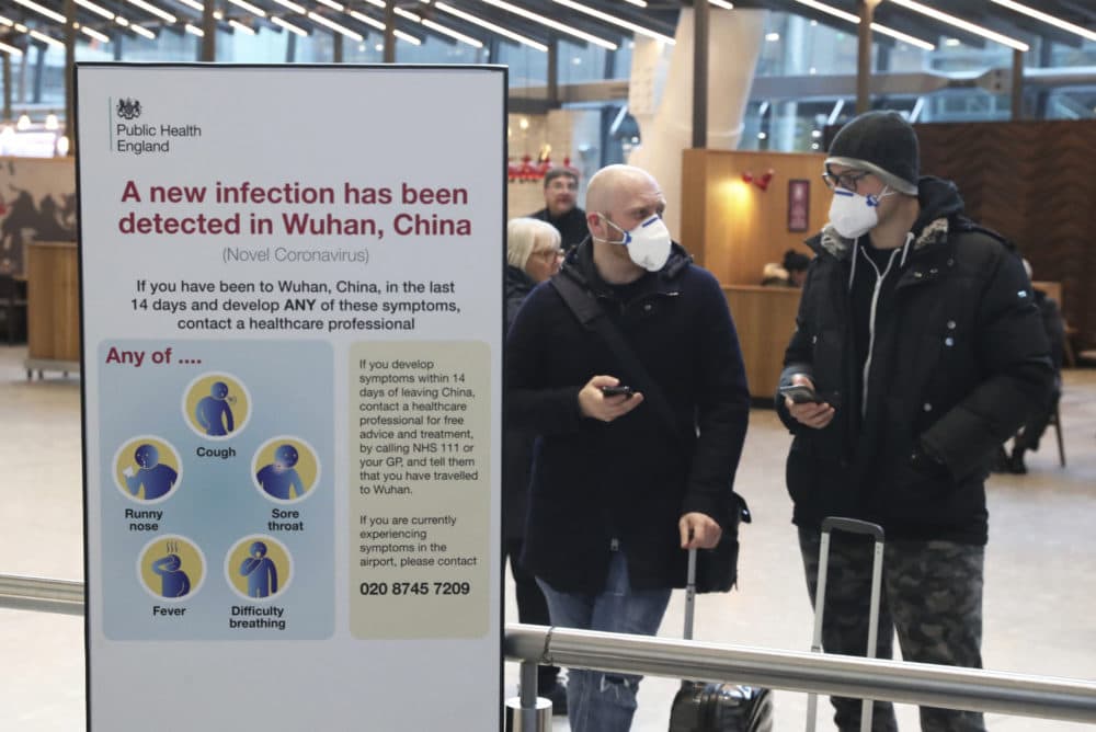 Passengers arrive at Heathrow Airport in London after the last British Airways flight from China touched down in the UK following an announcement that the airline was suspending all flights to and from mainland China with immediate effect amid the escalating coronavirus crisis on Jan. 29, 2020. (Steve Parsons/PA via AP)