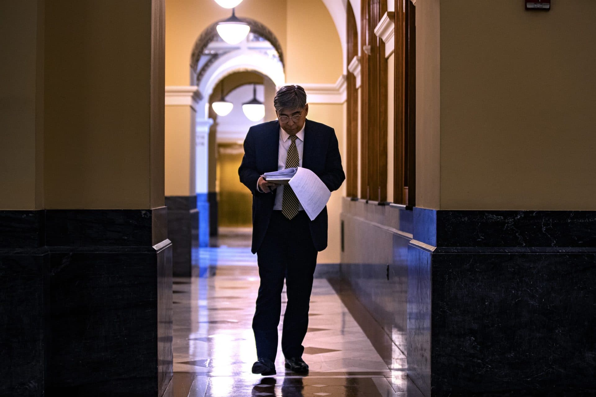 Attorney Hector Pineiro reviews documents related to a former inmate's case at John Adams Courthouse in Boston. (Jesse Costa/WBUR)