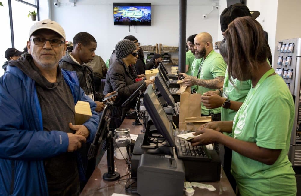 Business gets under way at Pure Oasis on Blue Hill Avenue in Dorchester, the first recreational marijuana store to open in Boston. (Robin Lubbock/WBUR)