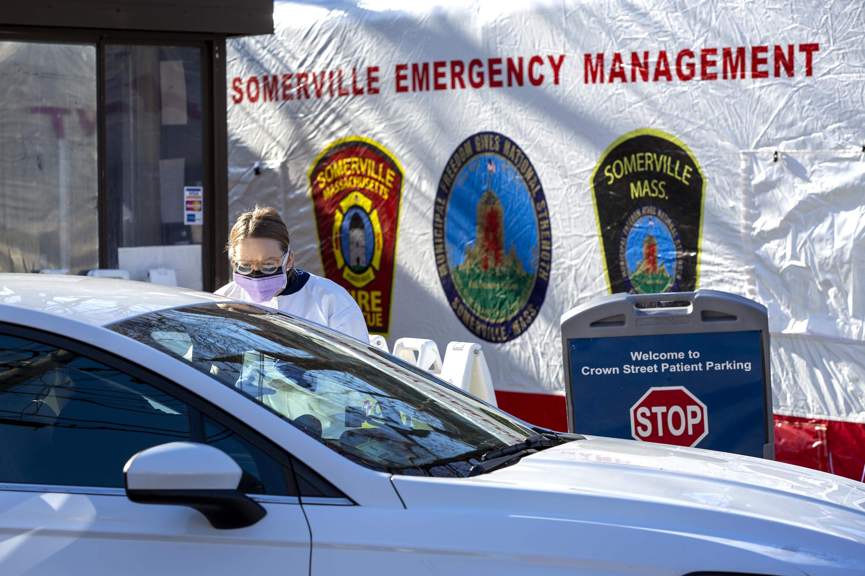 CHA Somerville Hospital staff check in a patient as the hospital opens its drive-through testing station to test patients for the coronavirus. (Robin Lubbock/WBUR)
