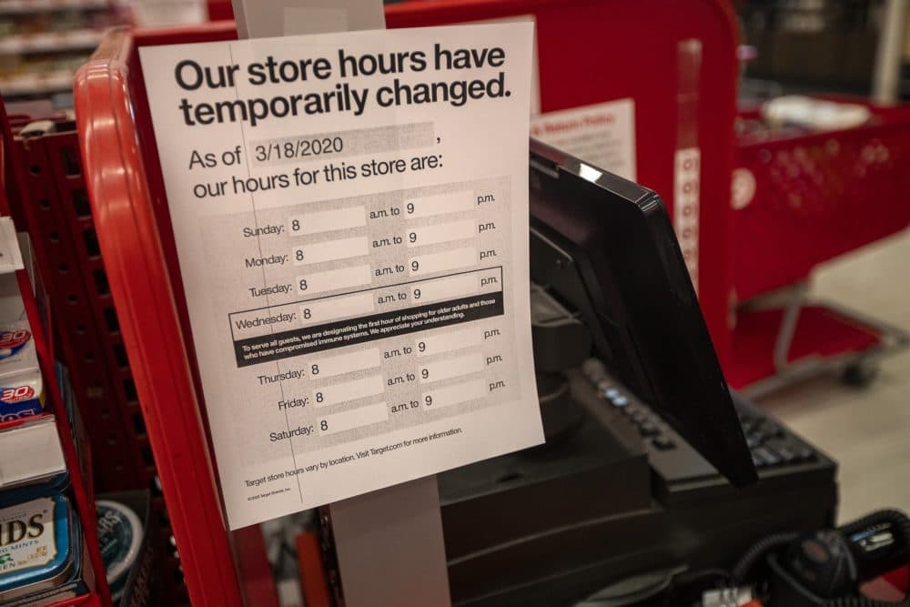 Notices at each Target register alert shoppers about the change in hours. (Jesse Costa/WBUR)
