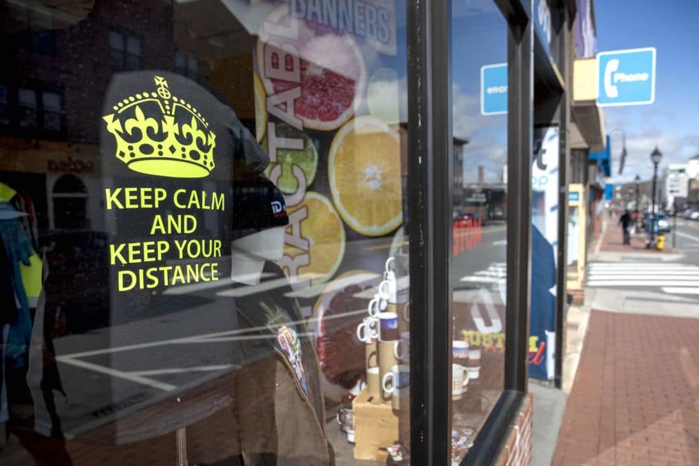 A T-shirt in the window of the iD art GraphicsShop on Moody Street says "Keep Calm And Keep Your Distance." (Robin Lubbock/WBUR)