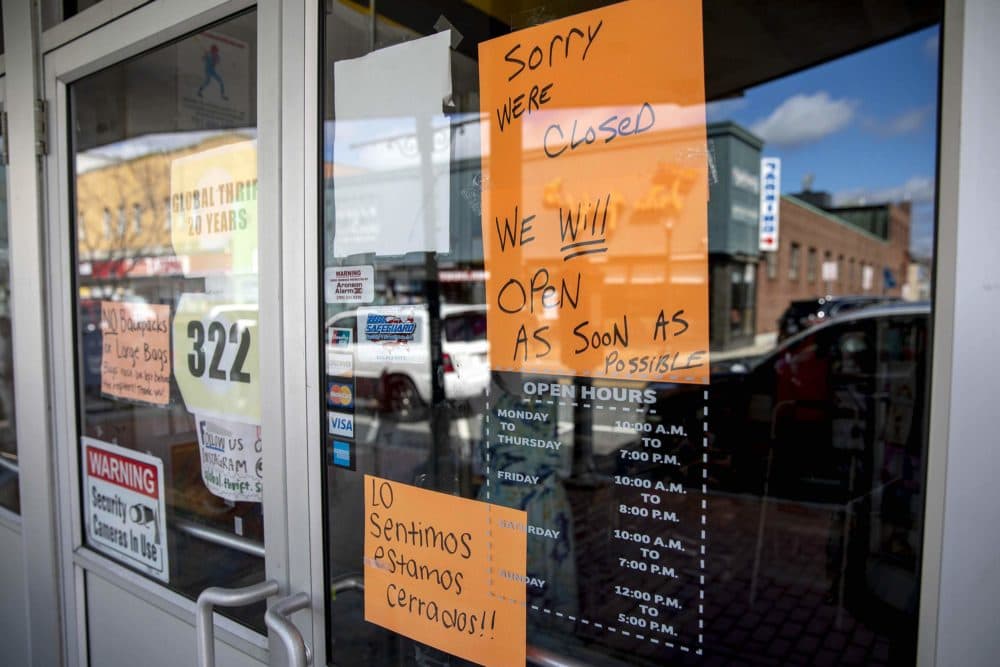 A sign on the closed thrift store on Moody Street says it will be open "as soon as possible." (Robin Lubbock/WBUR)