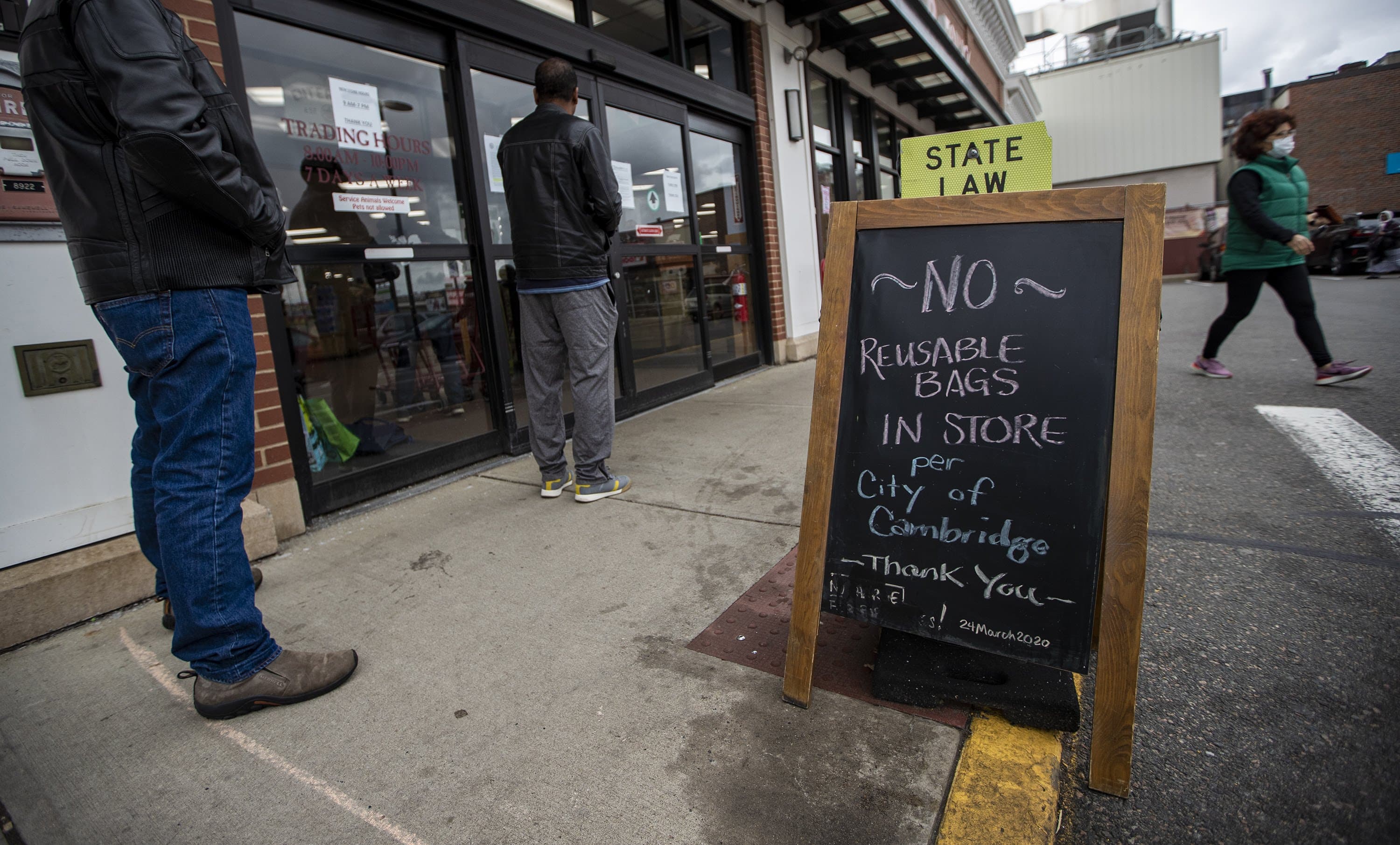 A sign out front at Trader Joe’s in Cambridge notifies shoppers reusable bags are not allowed in the store. (Jesse Costa/WBUR)