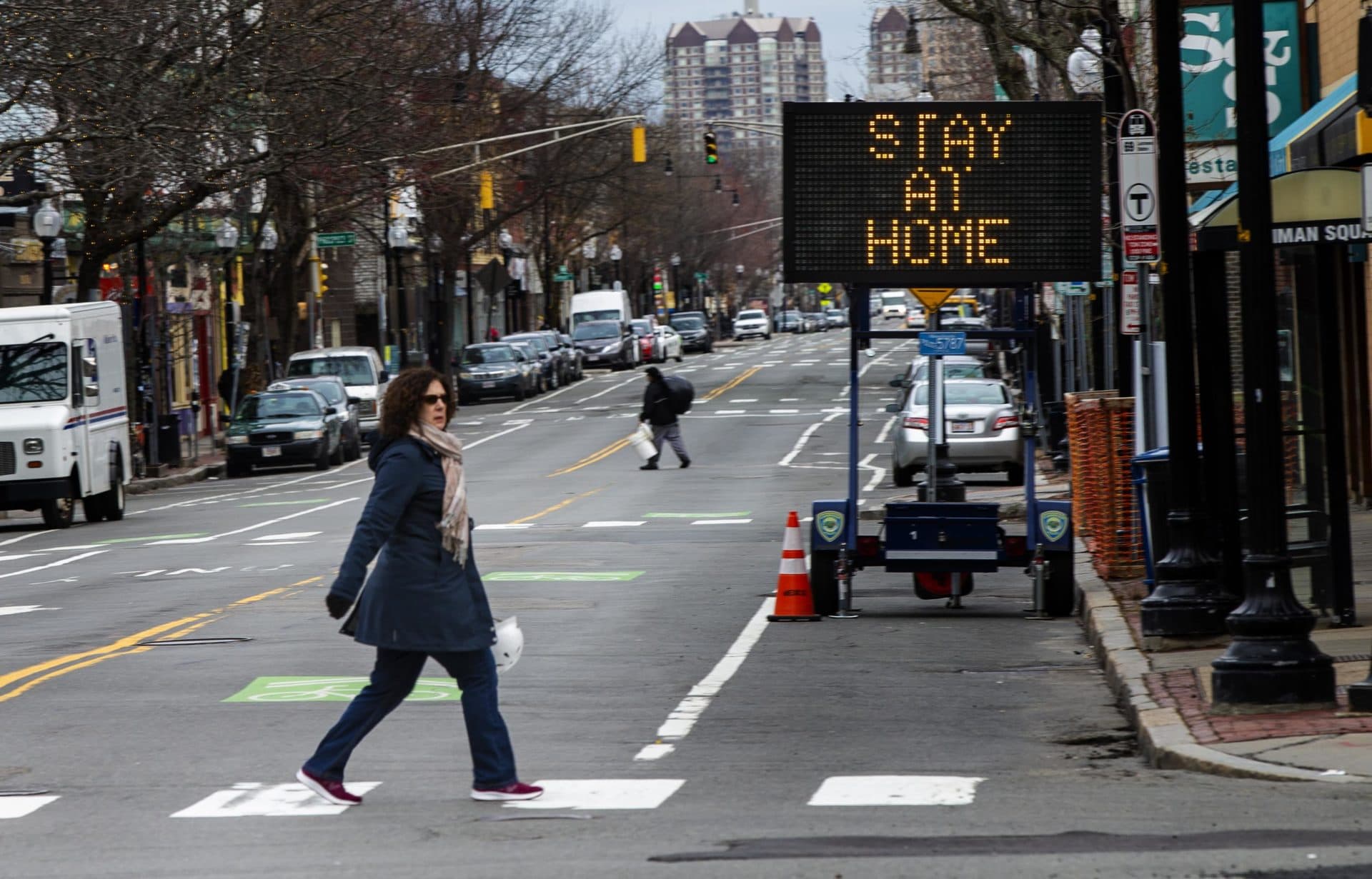 A sign in Inman Square in Cambridge urging residents to stay home during the Cornavirus epidemic. (Jesse Costa/WBUR)