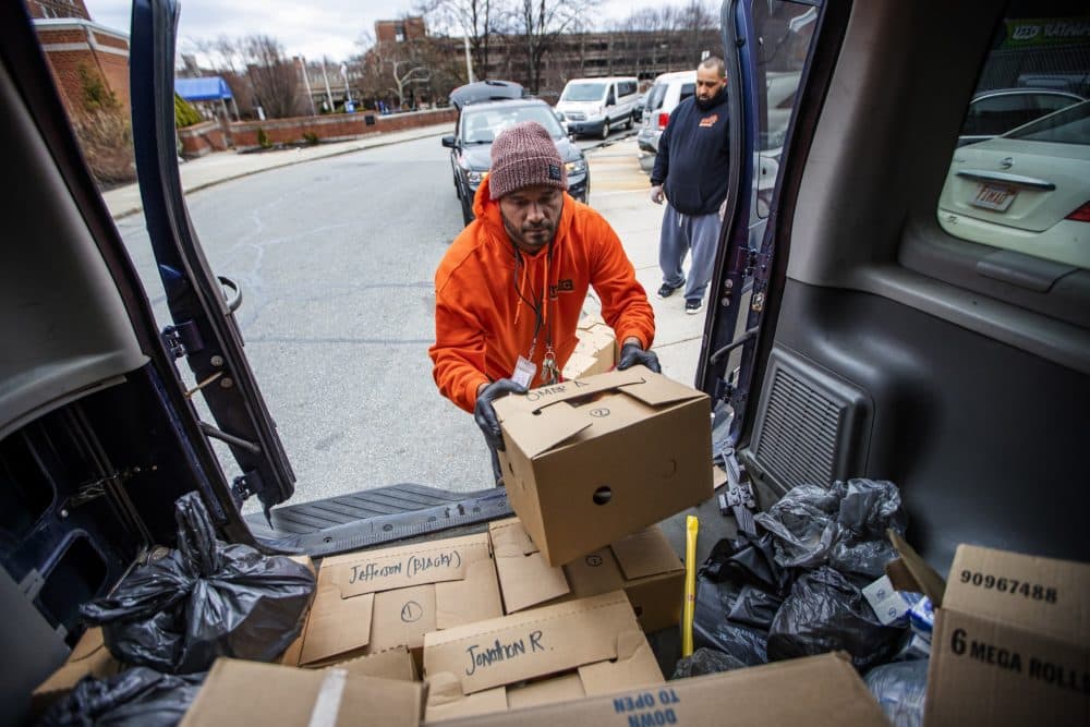 Jose Rivera loads meal boxes into a van for delivery. (Jesse Costa/WBUR)