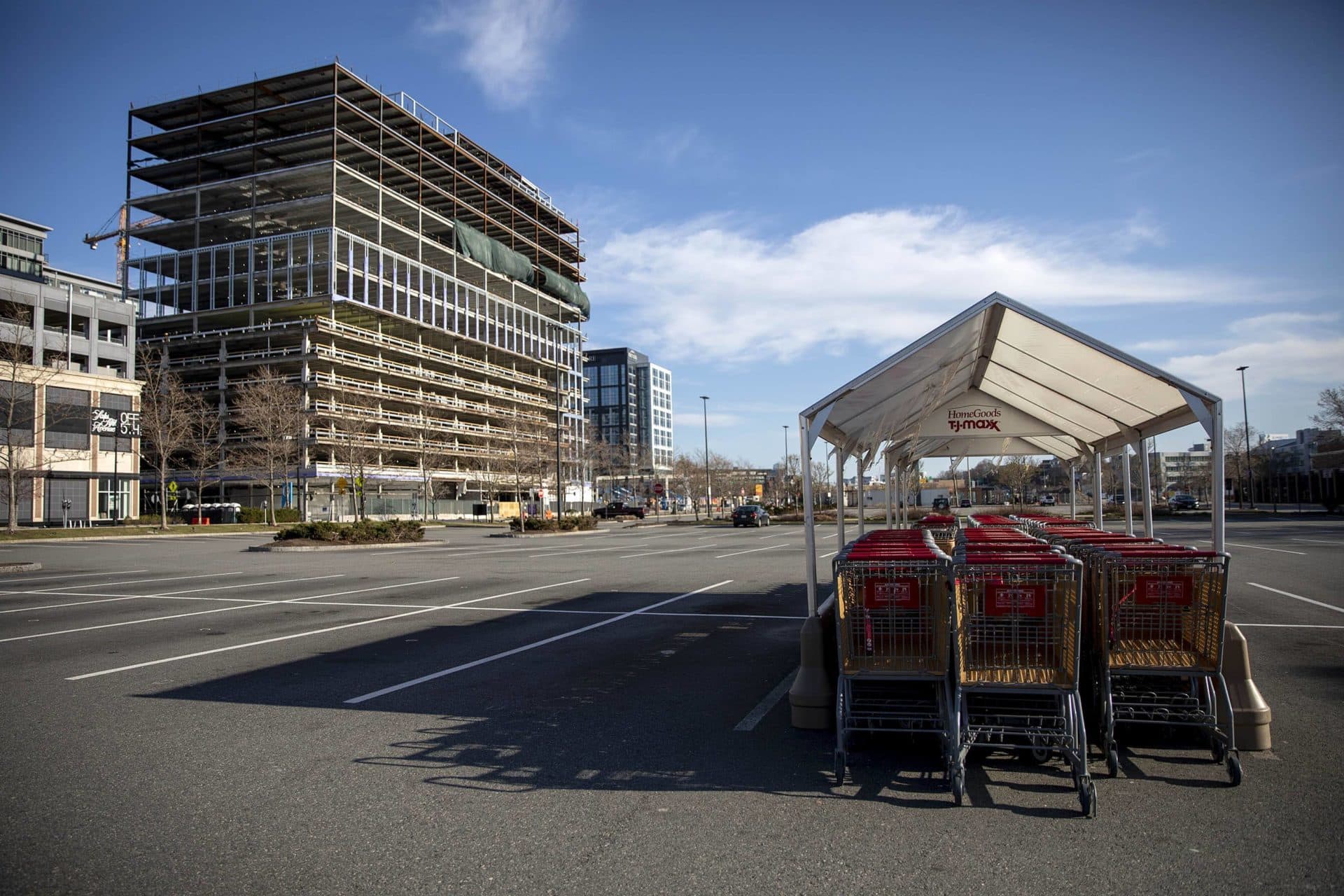 March 26: With stores closed and people staying home to slow the spread of the coronavirus, TJ Maxx carts stand idle in the empty parking lot in front of the store at Assembly Square in Somerville. (Robin Lubbock/WBUR)