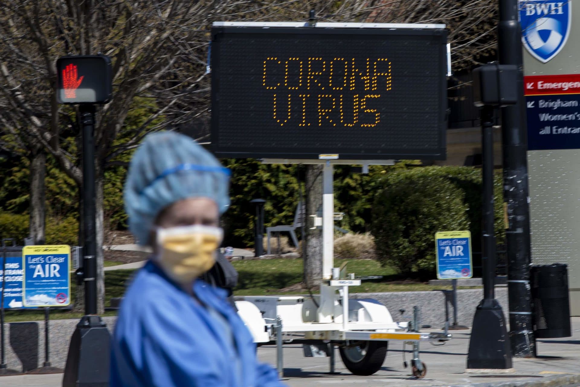 March 27: A health care worker looks to cross Huntington Avenue. (Jesse Costa/WBUR)