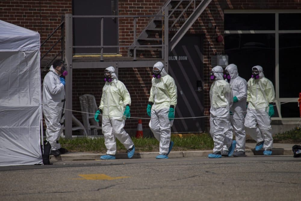 On March 31, a cleaning crew suited up with protective gear enters the Soldiers Home — a state-run long-term residence and health facility in Holyoke where more than a third of its veteran residents have died of COVID-19. (Jesse Costa/WBUR)