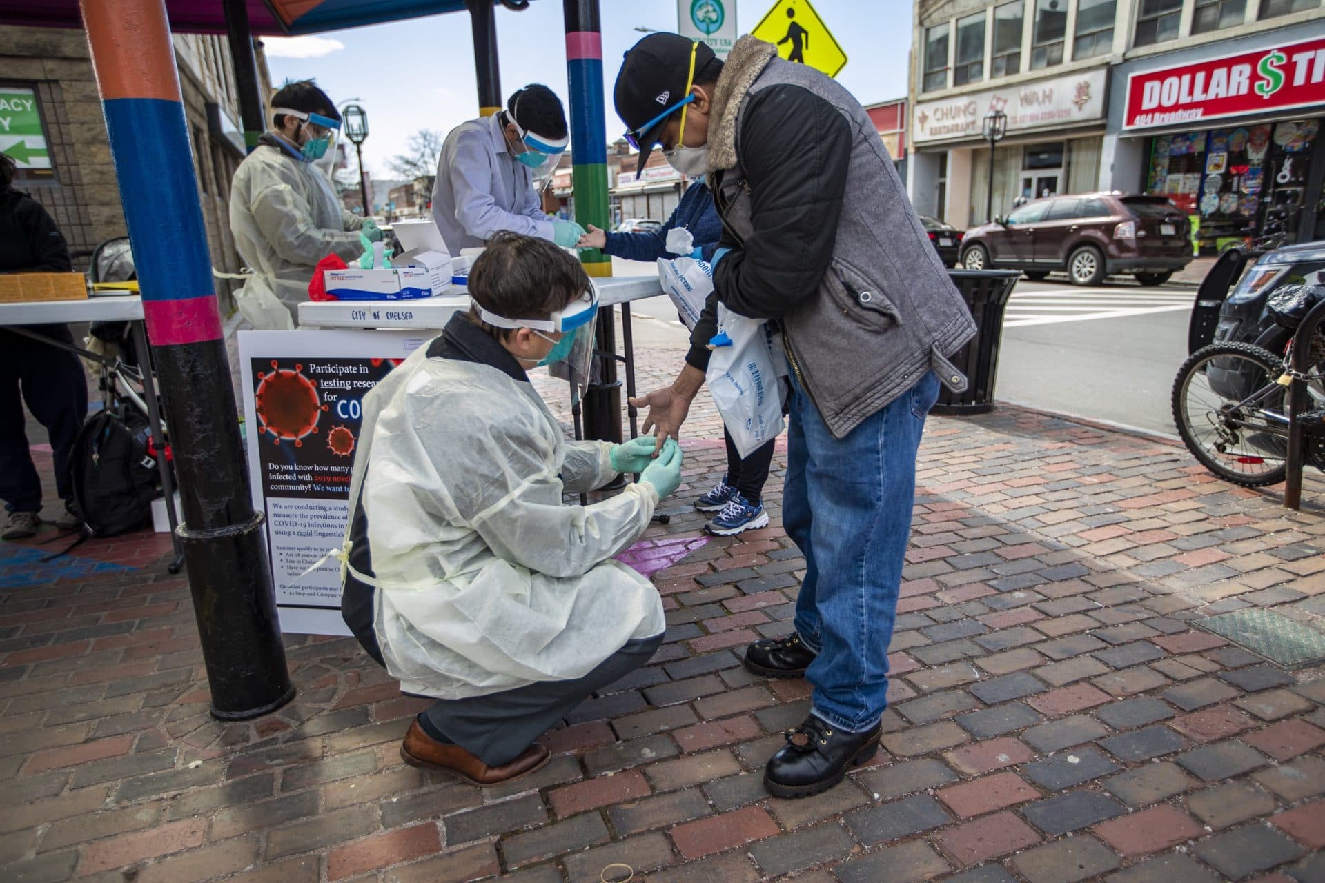 April 14: Dr. John Iafrate, a pathologist at Massachusetts General Hospital, takes a blood sample from a Chelsea resident at a pop-up testing facility in Bellingham Square. MGH is conducting a study by collecting the antibodies of Chelsea residents who have not tested positive for COVID-19, and they hope they will be able to measure the prevalence of infections in the community. (Jesse Costa/WBUR)