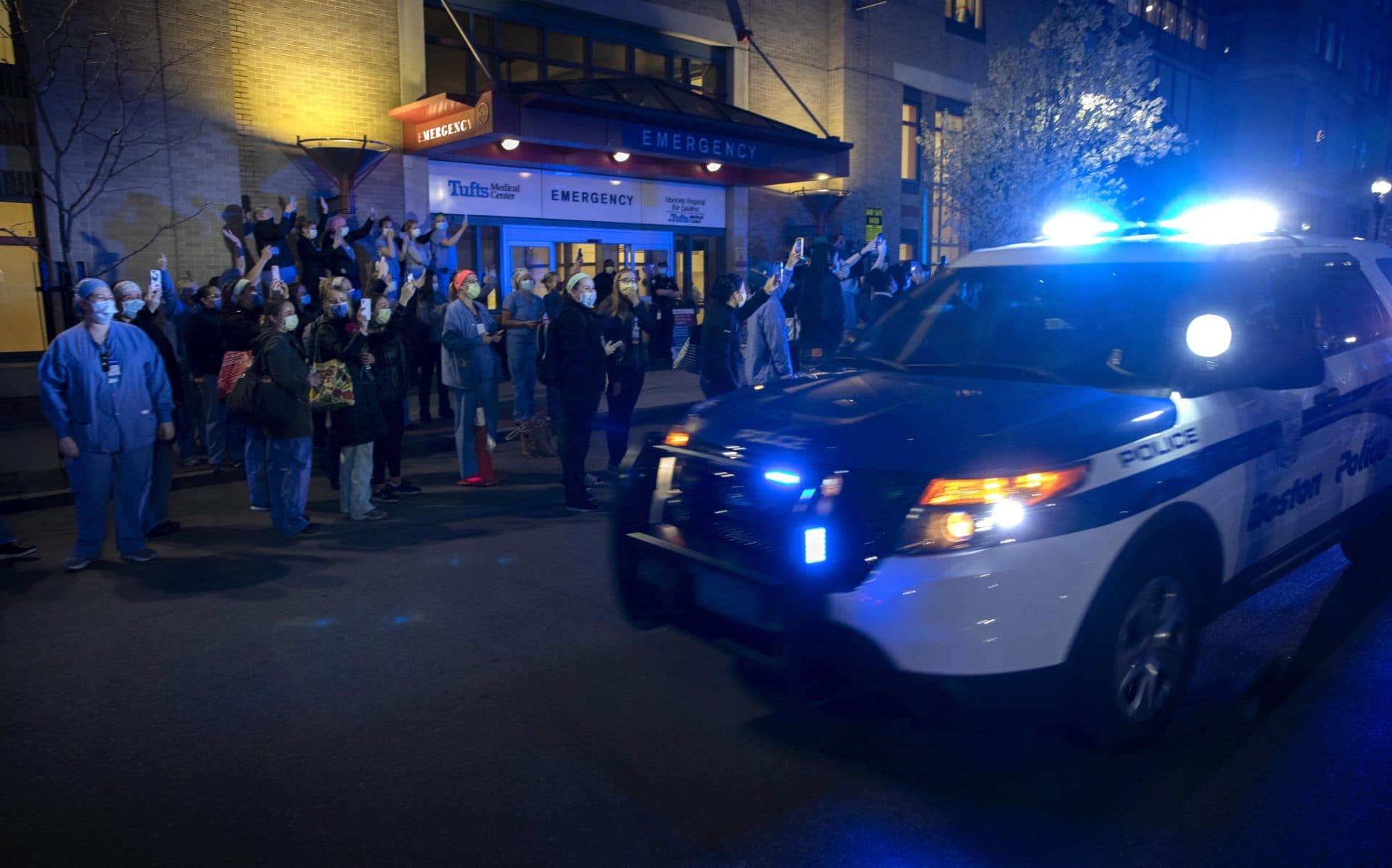 Boston public safety officials drove by Tufts Medical Center on Wednesday night as a show of support for healthcare workers. (Robin Lubbock/WBUR)