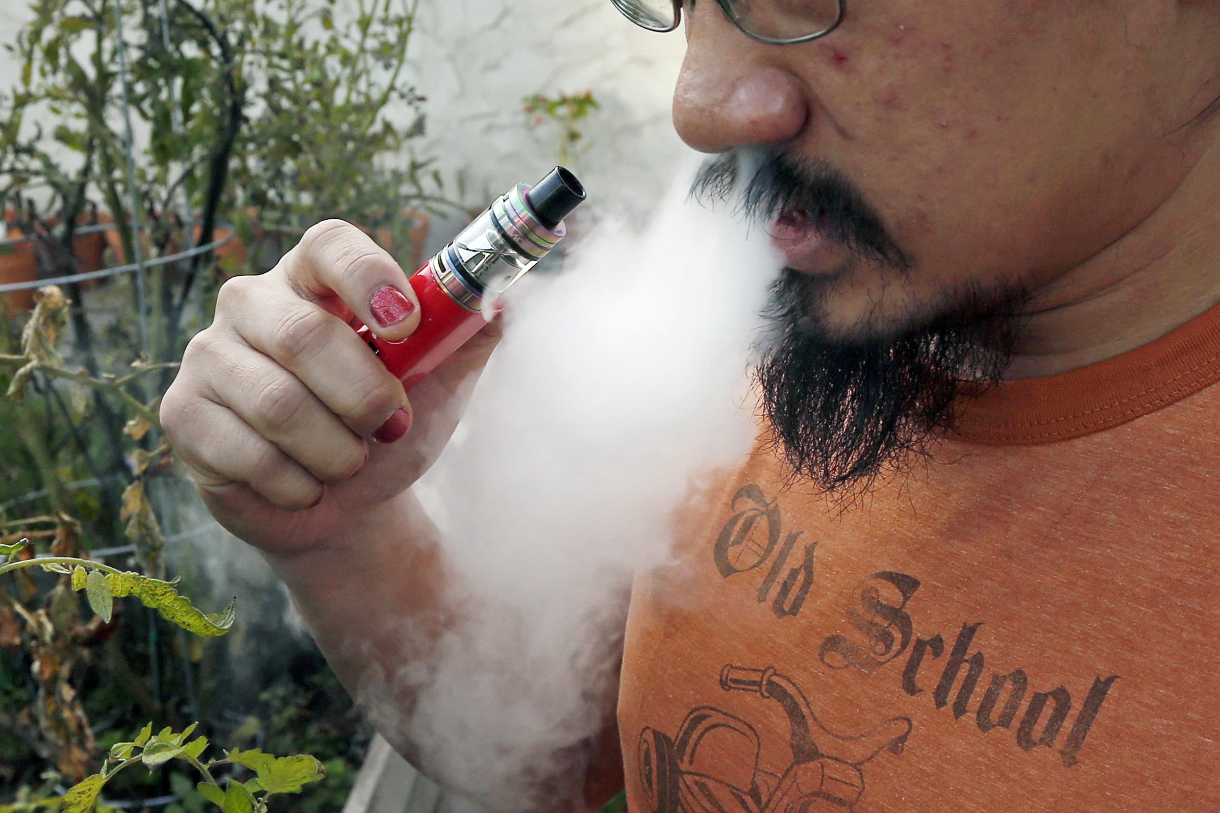 Some physicians are speculating that vaping could make some young people more susceptible to the worst complications. (Jim Mone/AP)