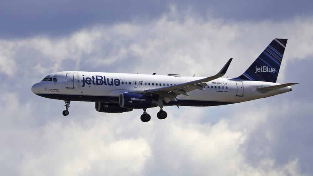 A JetBlue Airways flight flies into Salt Lake City International Airport. (Rick Bowmer/AP)