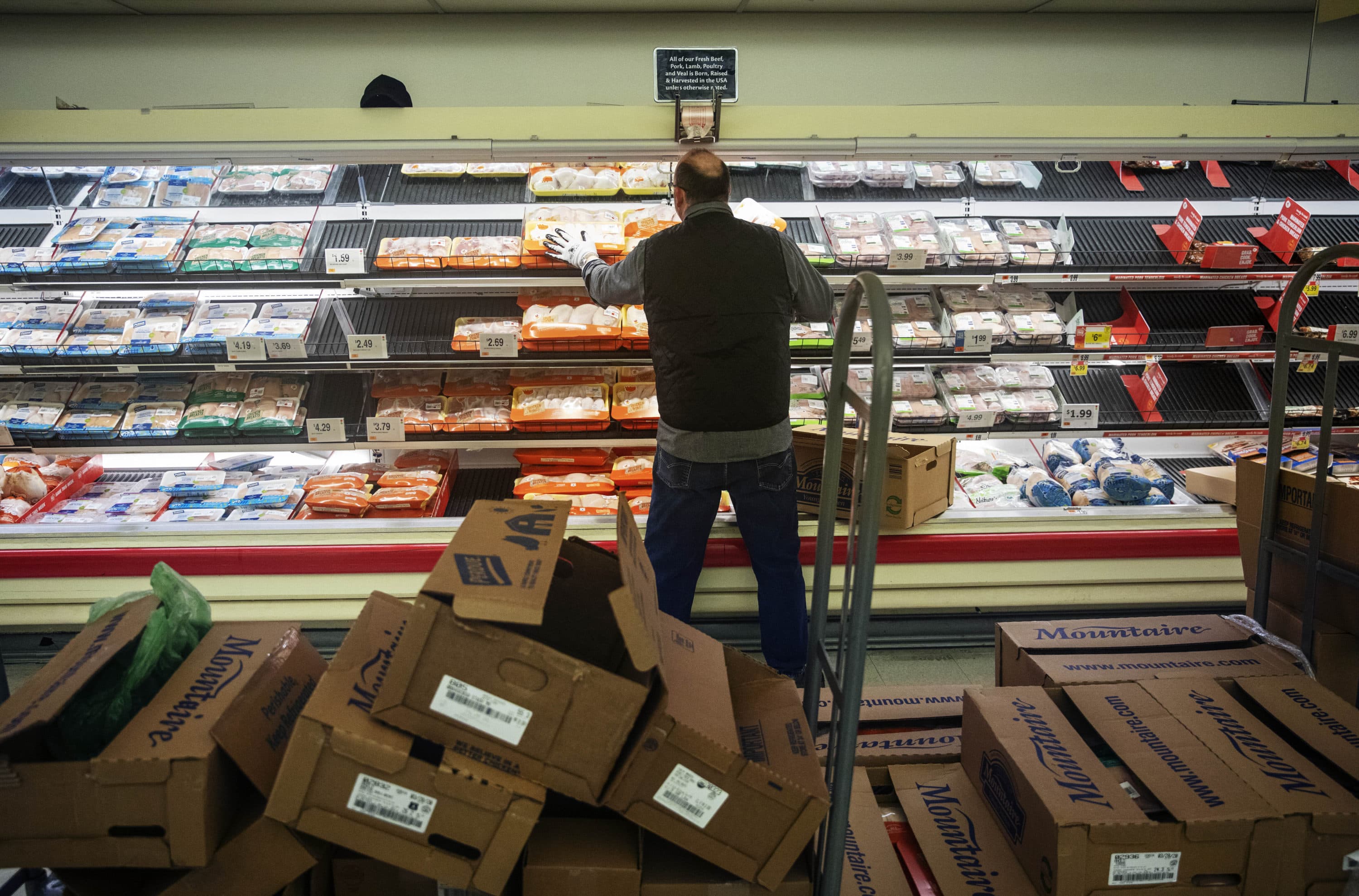 A worker restocks the meat section of a Stop & Shop supermarket during hours open daily only for seniors Thursday, March 19, 2020, in North Providence, R.I. (David Goldman/AP)