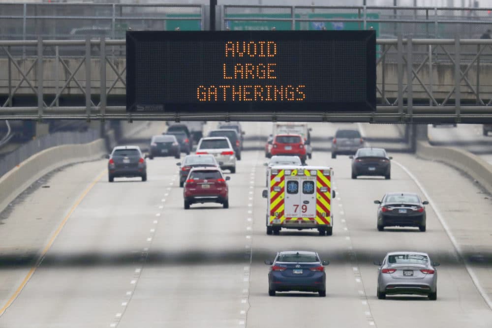 A public service announcement about coronavirus prevention is displayed on an electronic traffic message board as an ambulance travels northbound on Chicago's Dan Ryan Expressway, Thursday, March 19, 2020. (Charles Rex Arbogast/AP Photo)