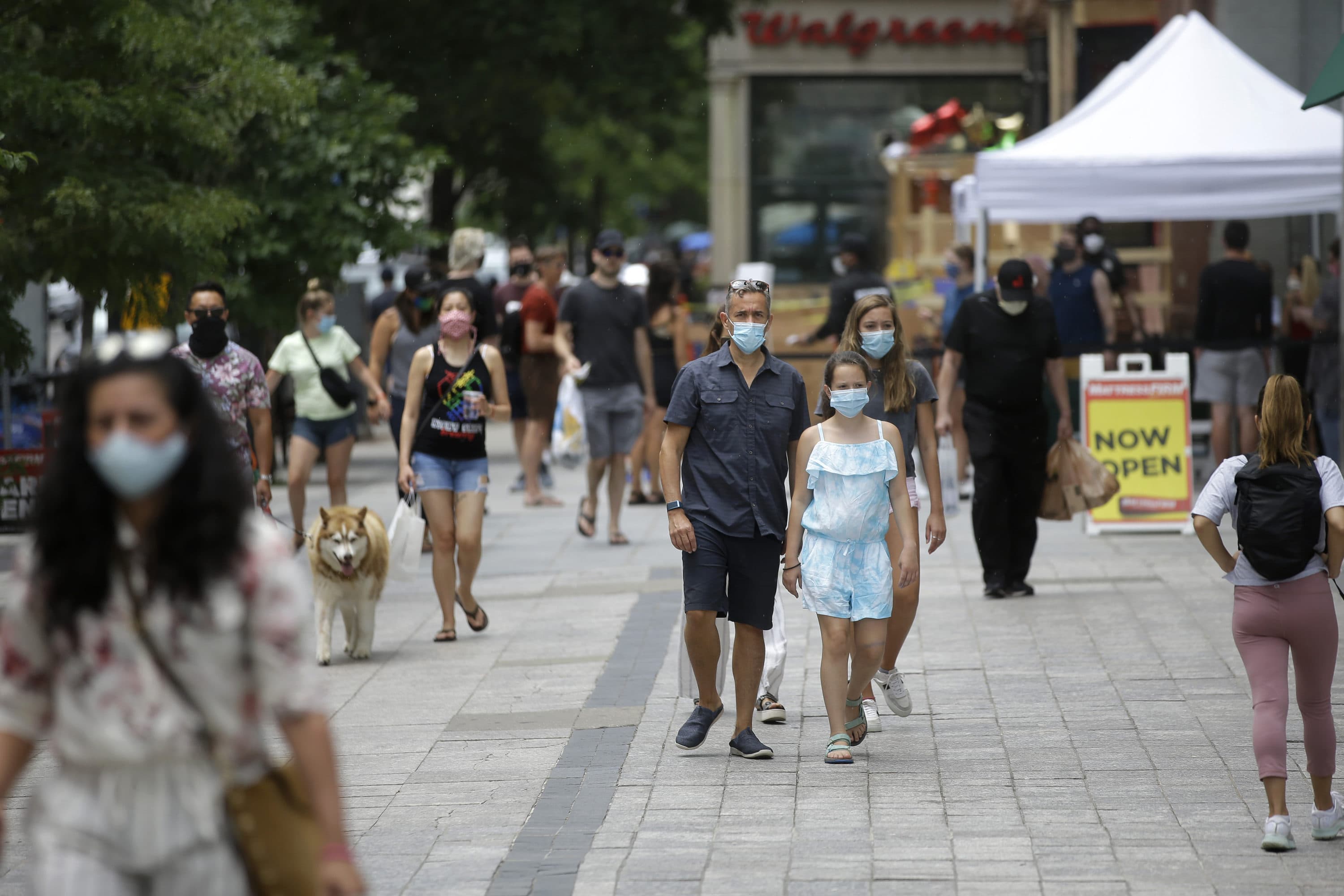 Pedestrians wear masks out of concern for the coronavirus, June 28, 2020, while walking along a sidewalk, in Boston.(Steven Senne/AP)