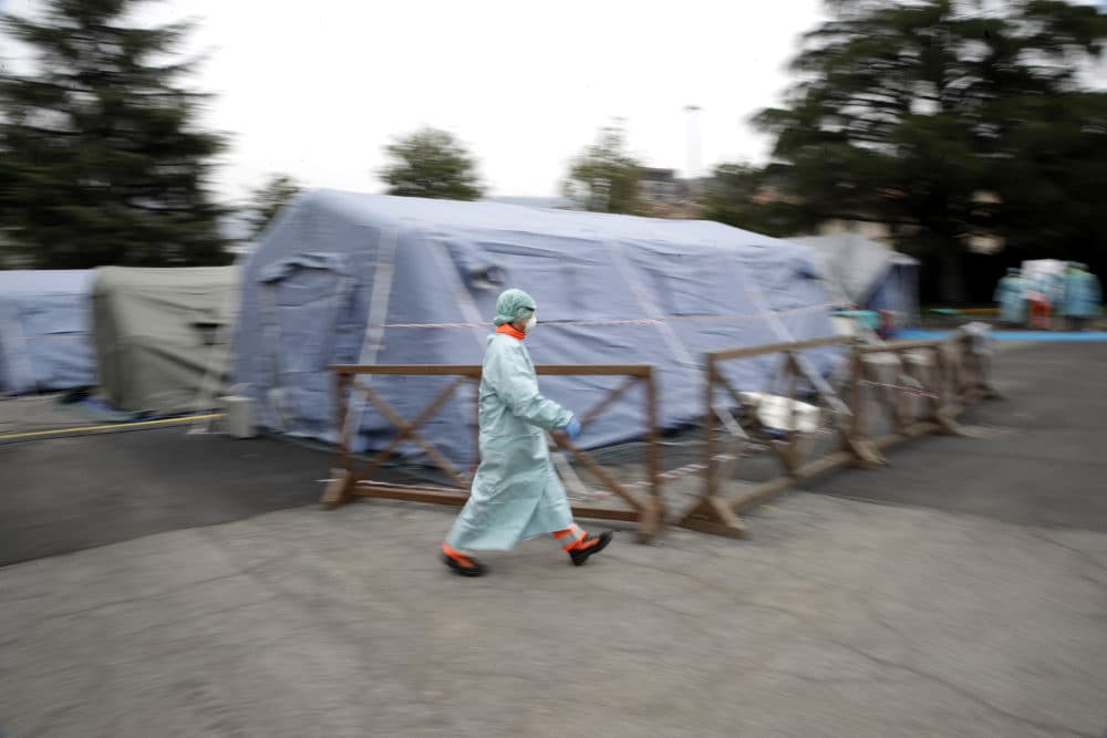 A staffer walks at one of the emergency structures that were set up to ease procedures at the Brescia hospital, northern Italy, Thursday, March 12. (Luca Bruno/AP)
