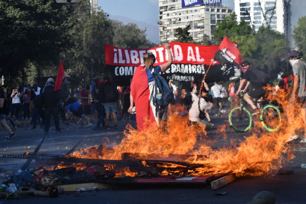 Protesters gather and burn garbage in Santiago's Plaza de la Dignidad. (Jorge Sanchez for WBUR)