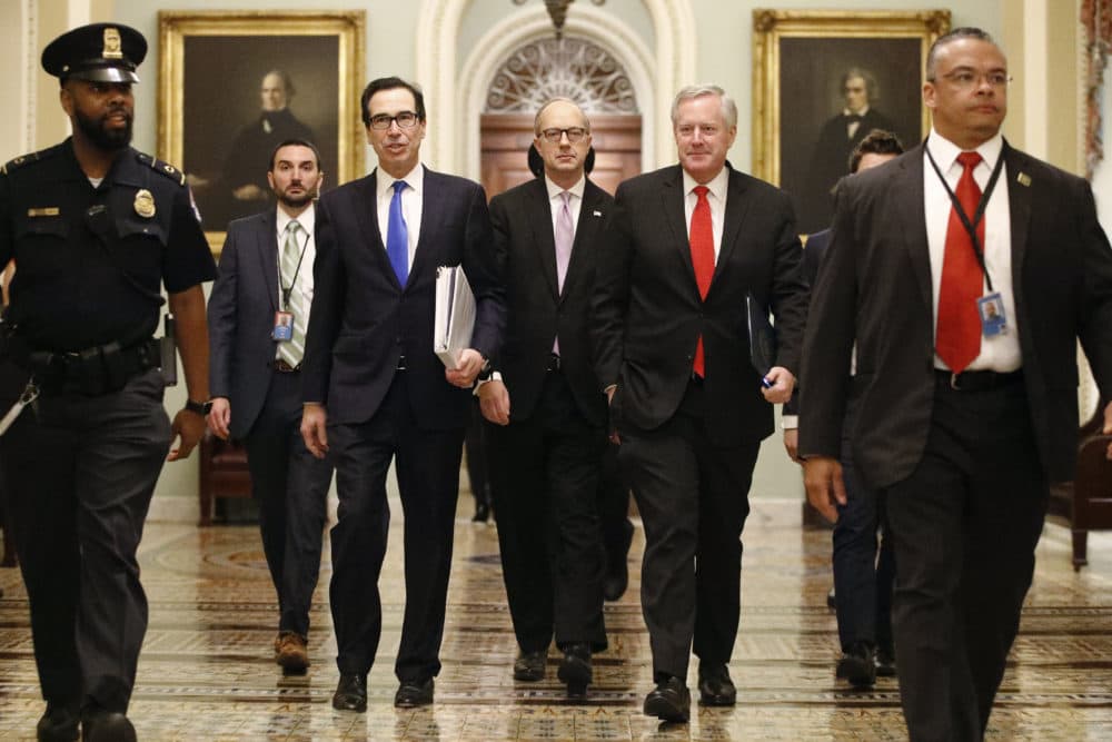 Treasury Secretary Steven Mnuchin, left, accompanied by White House Legislative Affairs Director Eric Ueland and acting White House chief of staff Mark Meadows, walks to the offices of Senate Majority Leader Mitch McConnell on Capitol Hill Tuesday, March 24, 2020. (Patrick Semansky/AP)