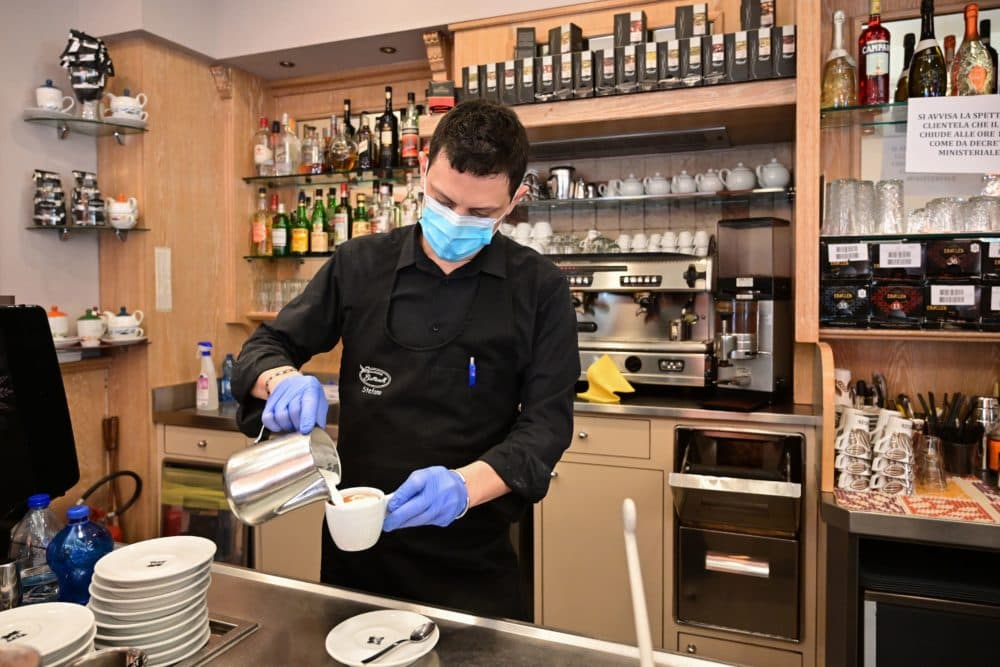 A waiter prepares a capuccino at a cafe in downtown Milan on March 10, 2020. (MIGUEL MEDINA/AFP via Getty Images)
