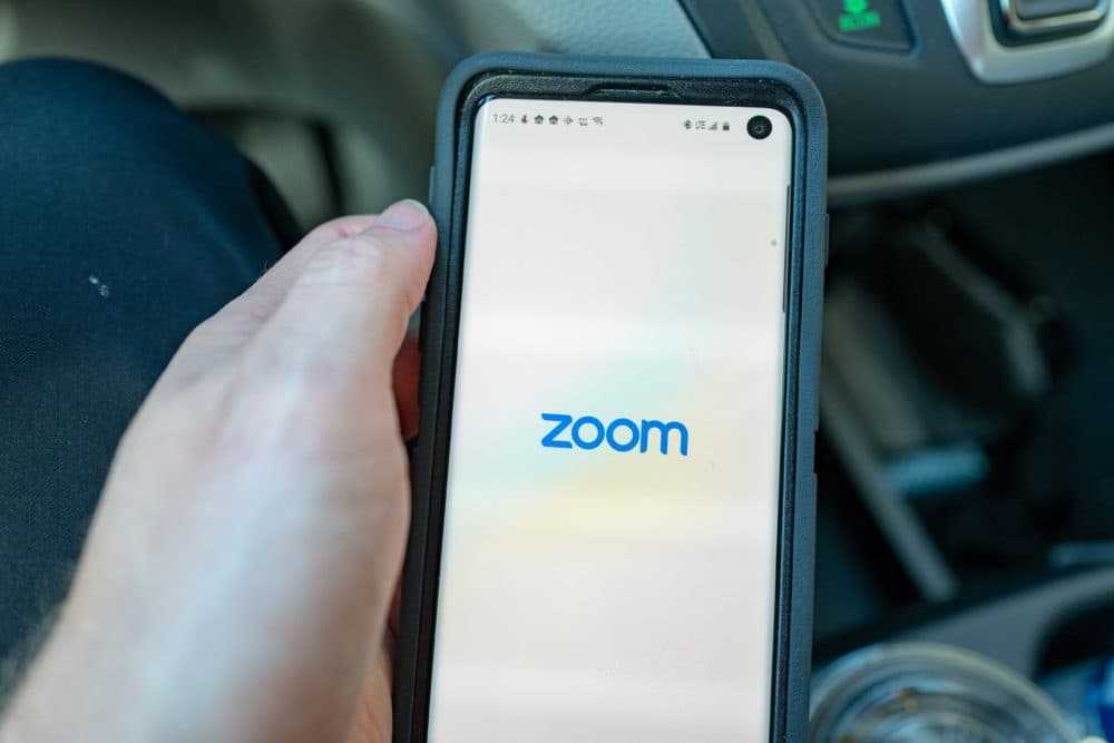 Close-up of hand of a man holding a Samsung Galaxy S10 smartphone with app for teleworking and conference call company Zoom, Walnut Creek, California, March 11, 2020. Amid an outbreak of the COVID-19 coronavirus, many companies have advised employees to work remotely, leading to strong financial performance from telework companies. (Photo by Smith Collection/Gado/Getty Images)