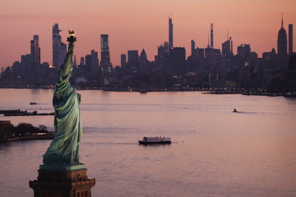Dawn breaks over The Statue of Liberty as Manhattan and the nation struggles to contain the number of coronavirus cases on March 18, 2020 in New York City. Across the city businesses, schools and places of work have been shutting down leading to empty streets and quiet neighborhoods. (Spencer Platt/Getty Images)