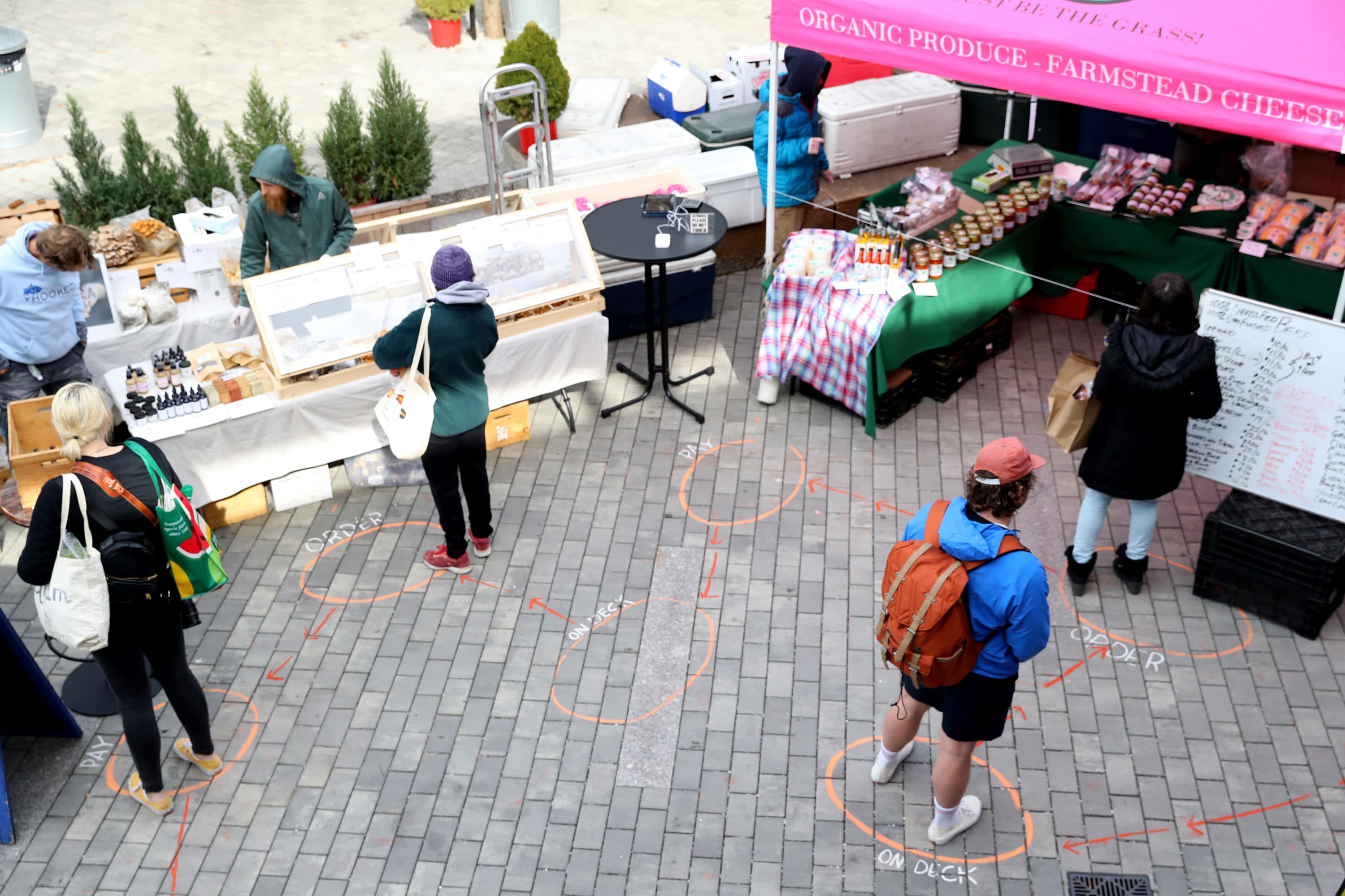 Shoppers wait in line at the Safe Supply outdoor grocery store at Bow Market on March 21, 2020 in Somerville, Massachusetts. (Maddie Meyer/Getty Images)