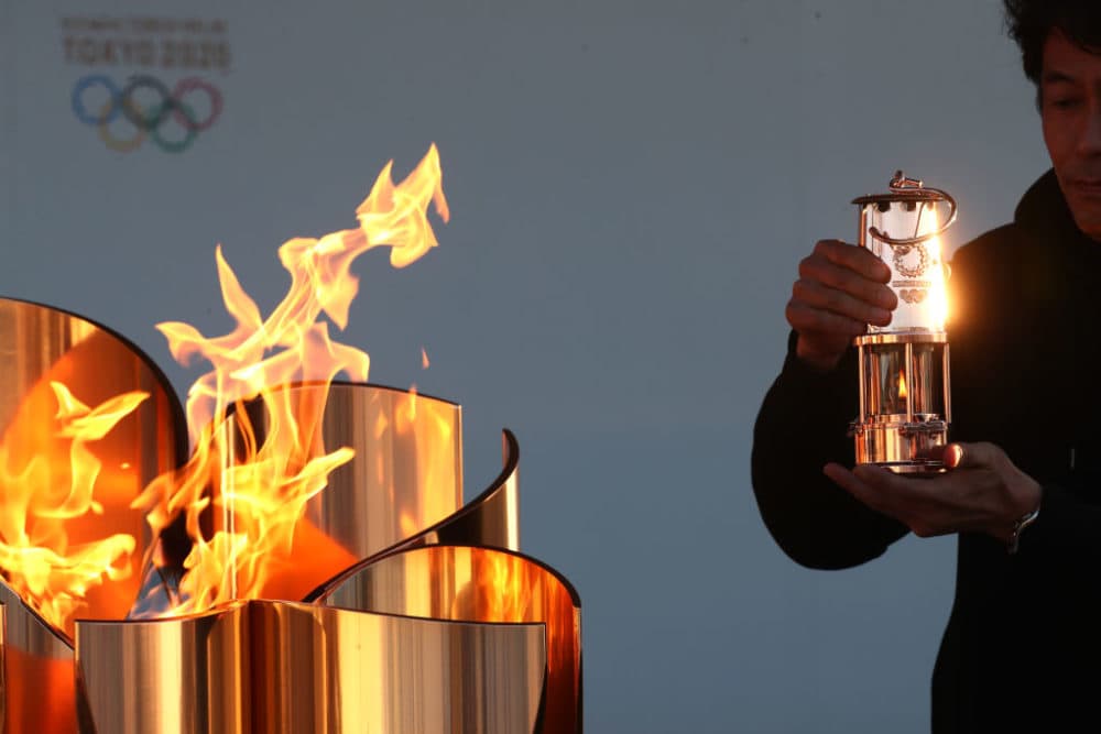 Before the decision was made to postpone the Games, the Olympic flame had already arrived in Japan. (Clive Rose/Getty Images)