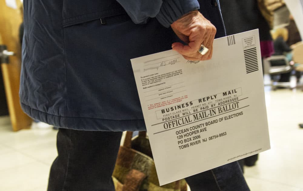 An Ocean County voter in Toms River, New Jersey, carries her completed ballot in an envelope on Nov. 5, 2012. (Paul J. Richards/AFP/Getty Images)