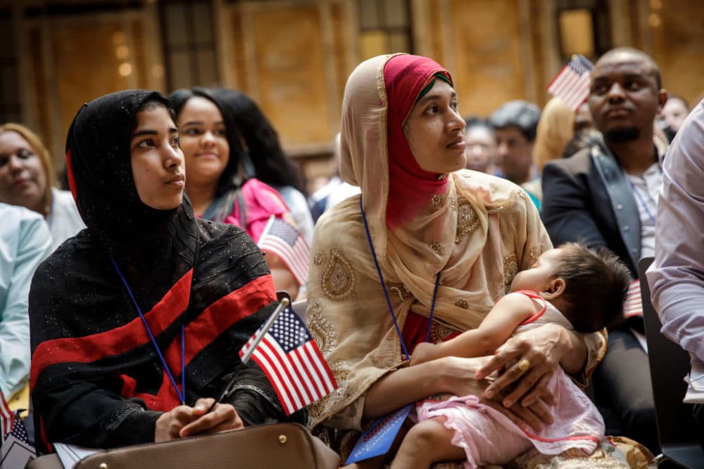 Mosammat Rasheda Akter, originally from Bangladesh, holds her 7 month-old daughter Fahmida as she waits to officially become a U.S. Citizen during a naturalization ceremony at the New York Public Library, July 3, 2018 in New York City. (Drew Angerer/Getty Images)