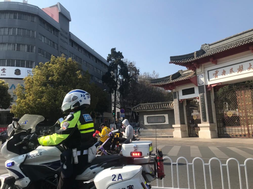 More police have been patrolling the streets since the coronavirus outbreak in Kunming. Here is a police officer at a red light in front of Yunnan Minzu University on February 22, 2020. (Courtesy)