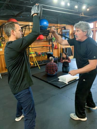 Randy Devitt working out with Nate Coomer. (Cloe Axelson/WBUR)