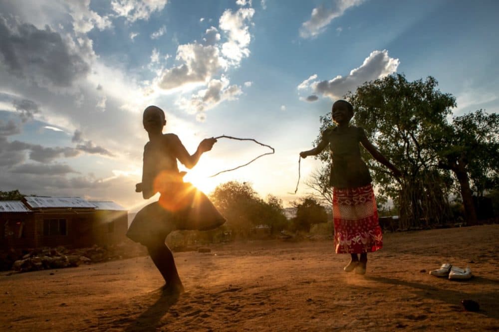 Alice Kanjinga (left), 6, jumps rope at her family's home in Kamdzandi Village, near PIH-supported Lisungwi Community Hospital in Neno District, Malawi. (Karin Schermbrucker/ Partners In Health)