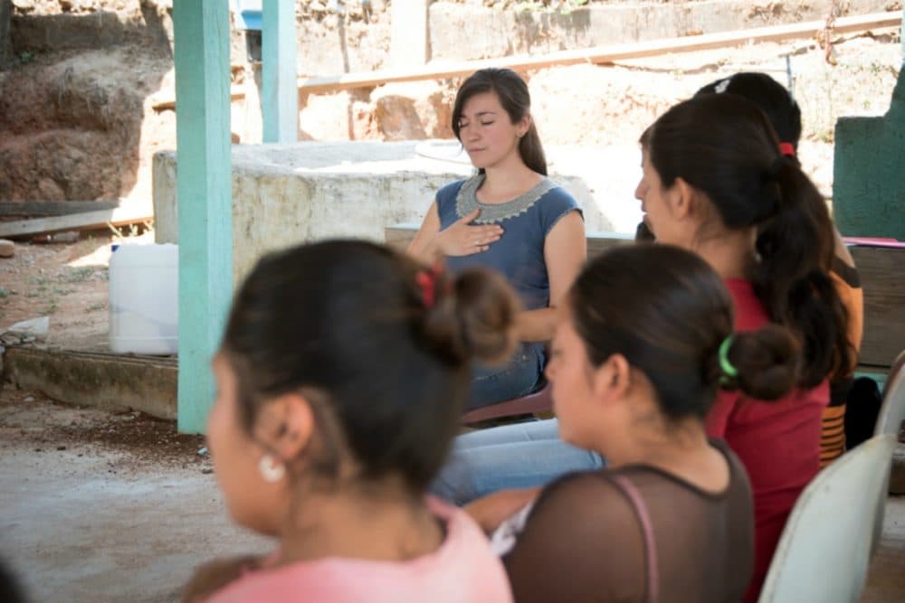 Dr. Fátima Rodríguez (center), who directs the mental health program for PIH in Mexico, leads a yoga and mindfulness session in 2017 for community health workers during a training in Capitán, a rural community in Chiapas. (Mary Schaad/Partners In Health)