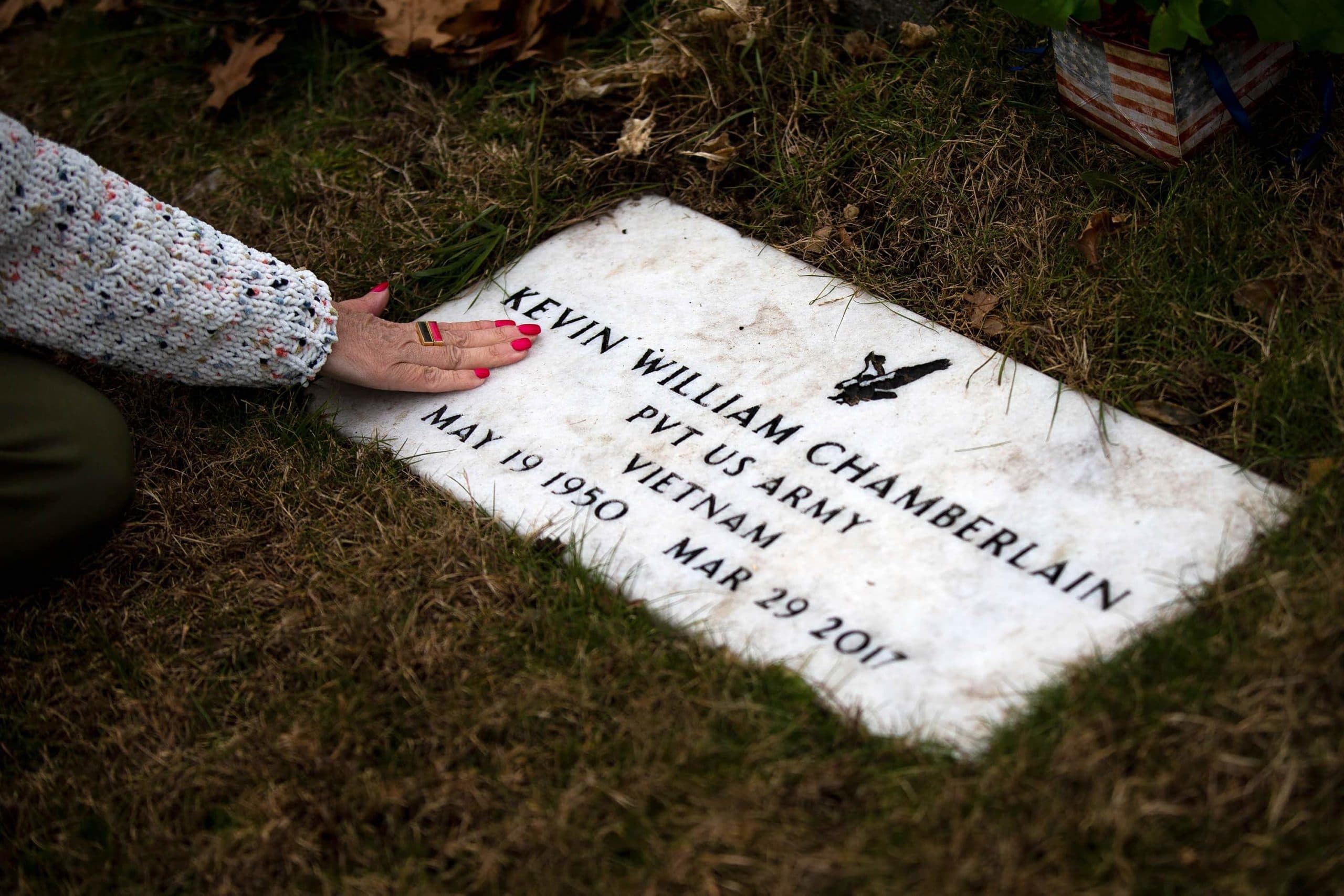 Susan Chamberlain visits the grave of her husband, Kevin Chamberlain. (Jesse Costa/WBUR)