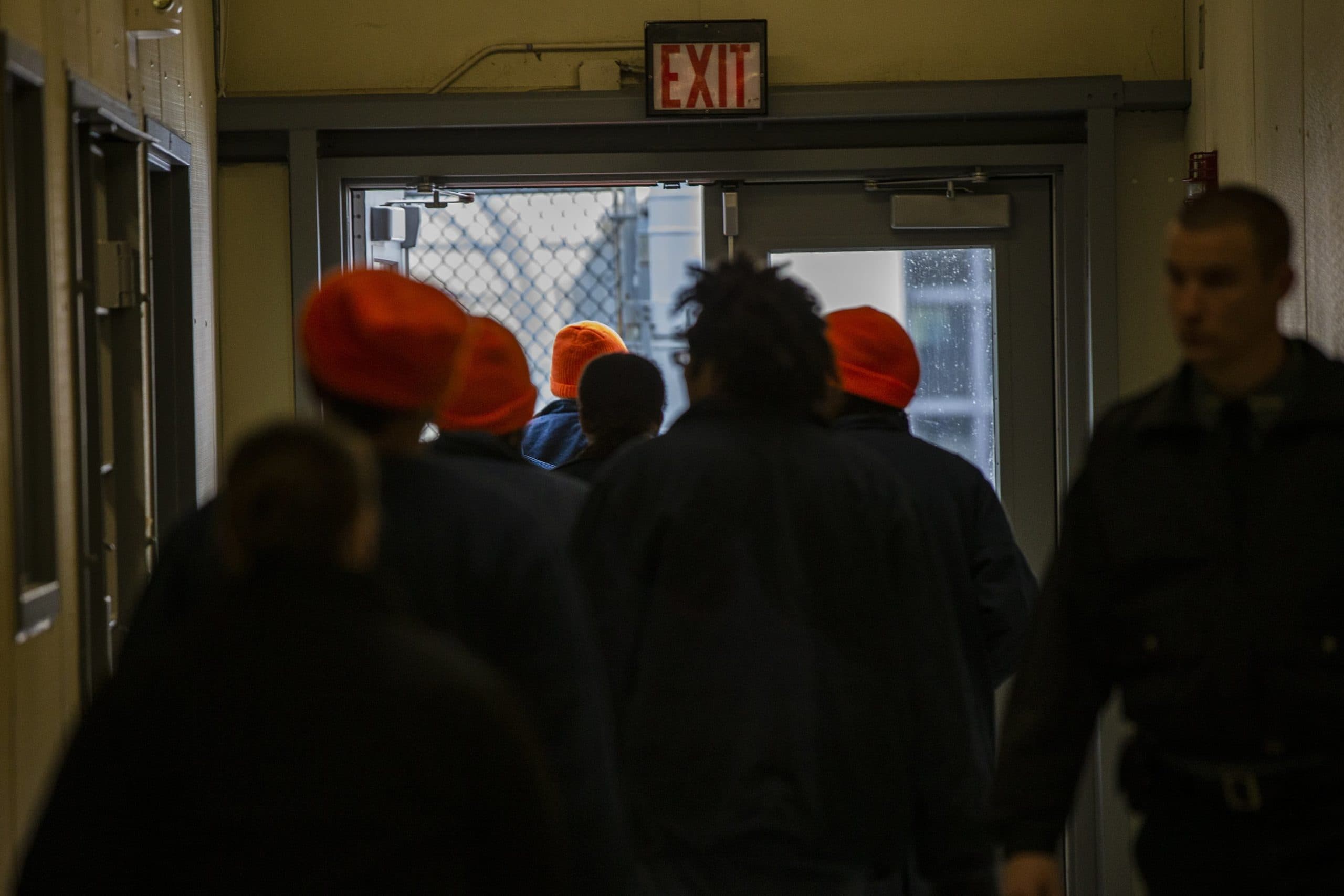 An Essex County jail corrections officer escorts inmates out of their cell block. (Jesse Costa/WBUR)