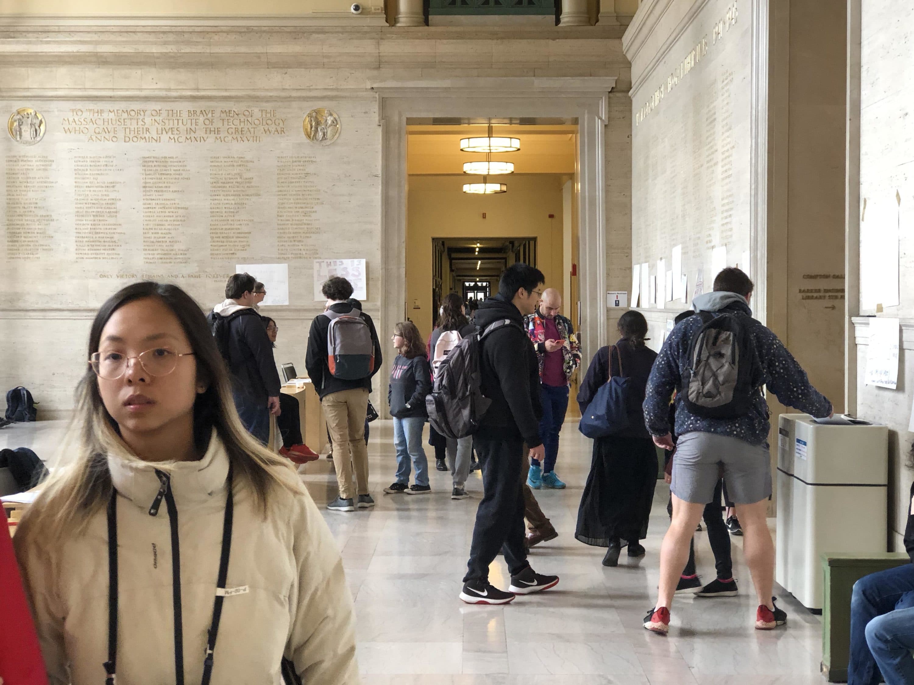 Students gathered in MIT's Memorial Lobby Thursday to protest what they saw as an uncompromising policy toward vulnerable students having to move. (Max Larkin/WBUR)