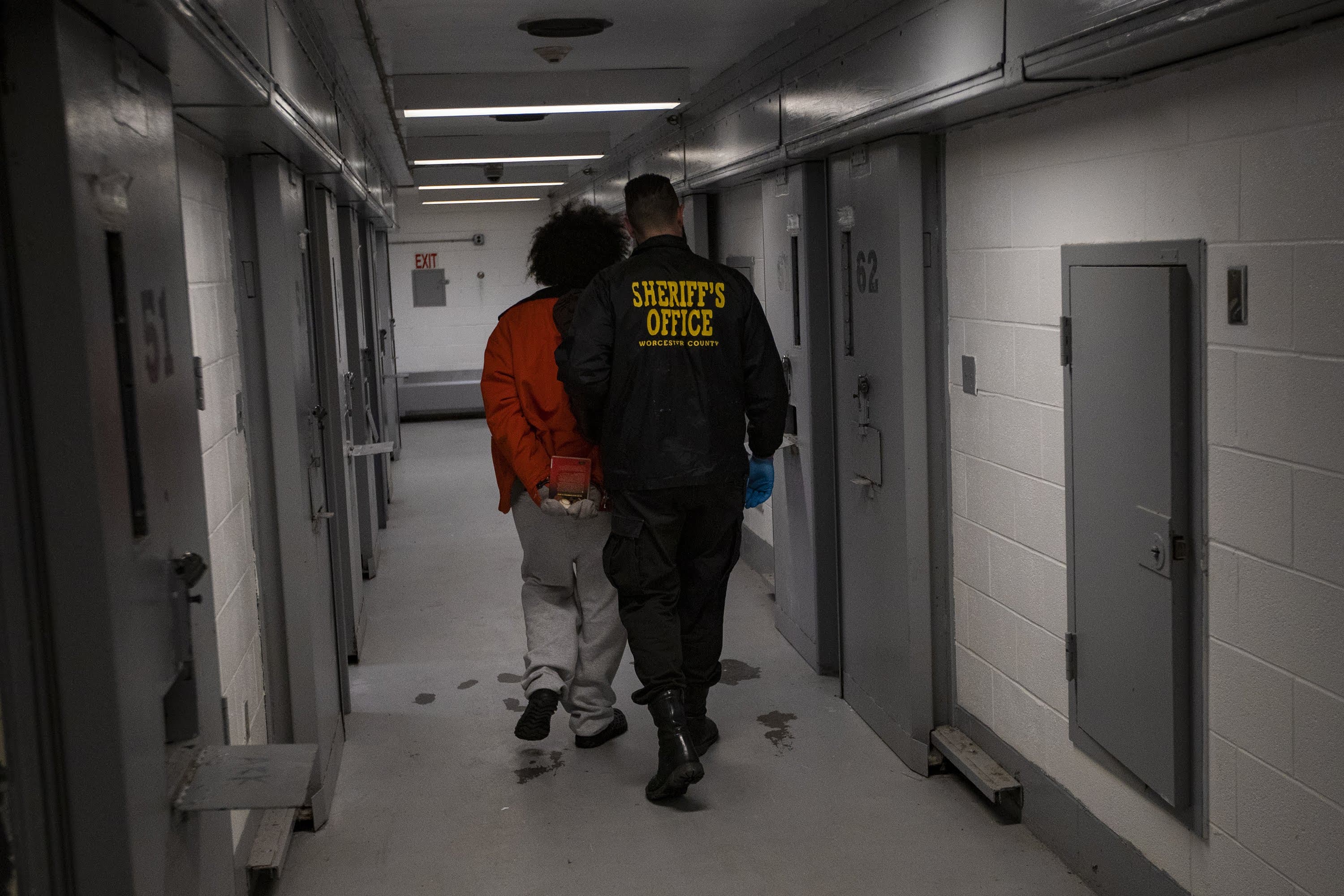 An inmate walks down a hallway inside the Worcester County jail. (Jesse Costa/WBUR)