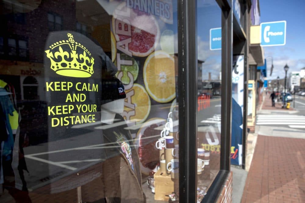 A T-shirt in the window of the iD art GraphicsShop on Moody Street, Waltham, says "Keep Calm And Keep Your Distance." (Robin Lubbock/WBUR)