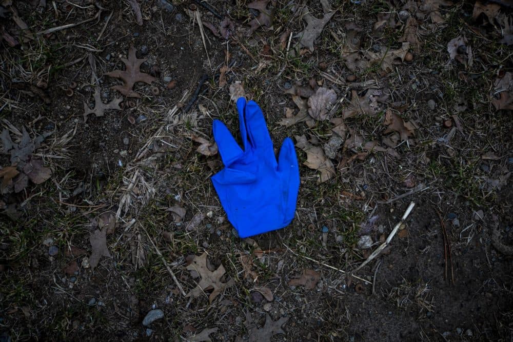 A discarded nitrile glove on the ground on the Fellsway in Medford. (Jesse Costa/WBUR)