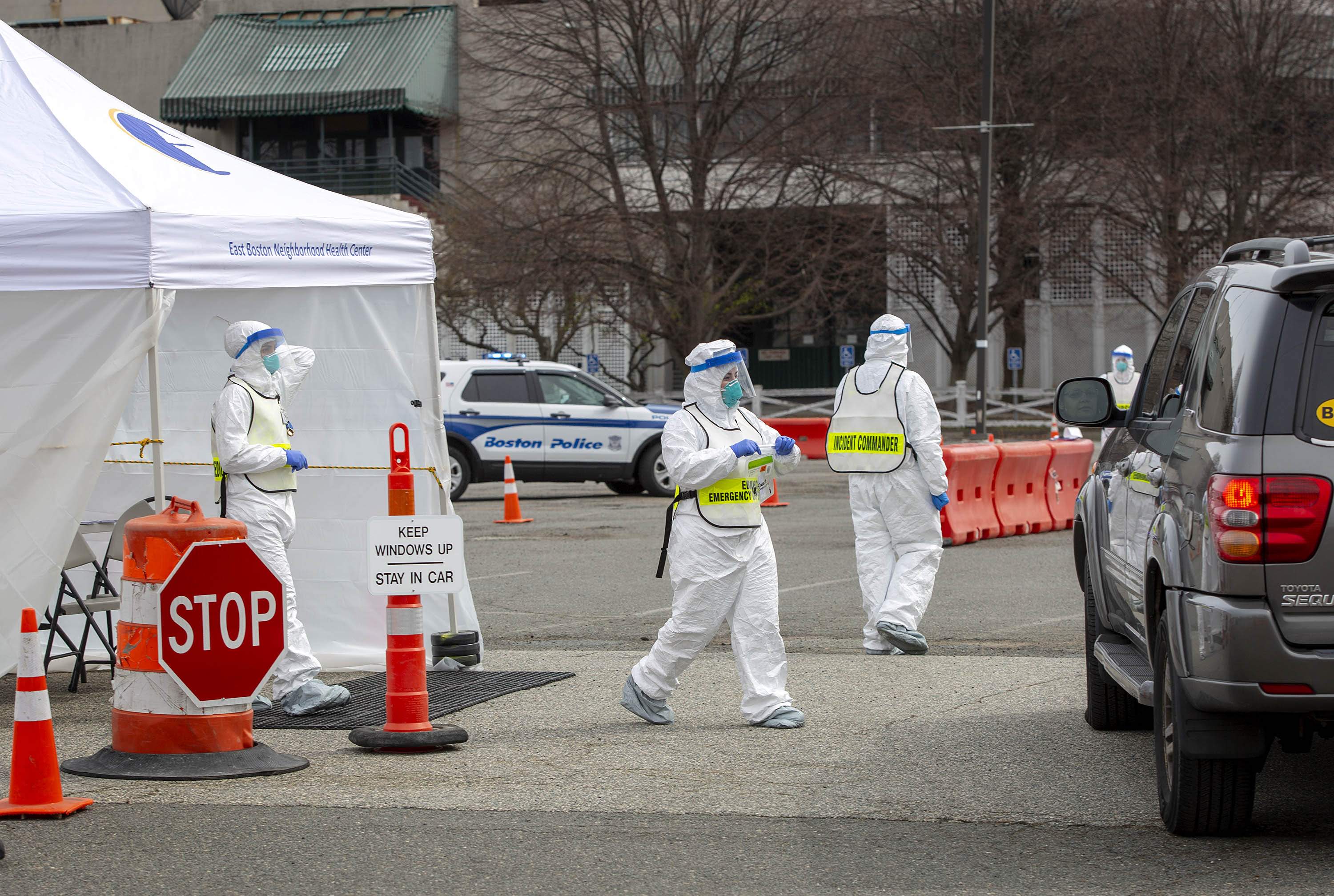 Medical staff check in a person at the drive through COVID-19 testing station at Suffolk Downs. (Robin Lubbock/WBUR)