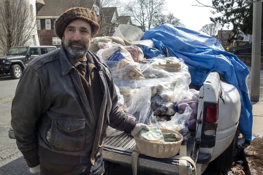 Michael Docter of Winter Moon Roots distributes root vegetables from the back of his truck in Somerville. (Andrea Shea/WBUR)