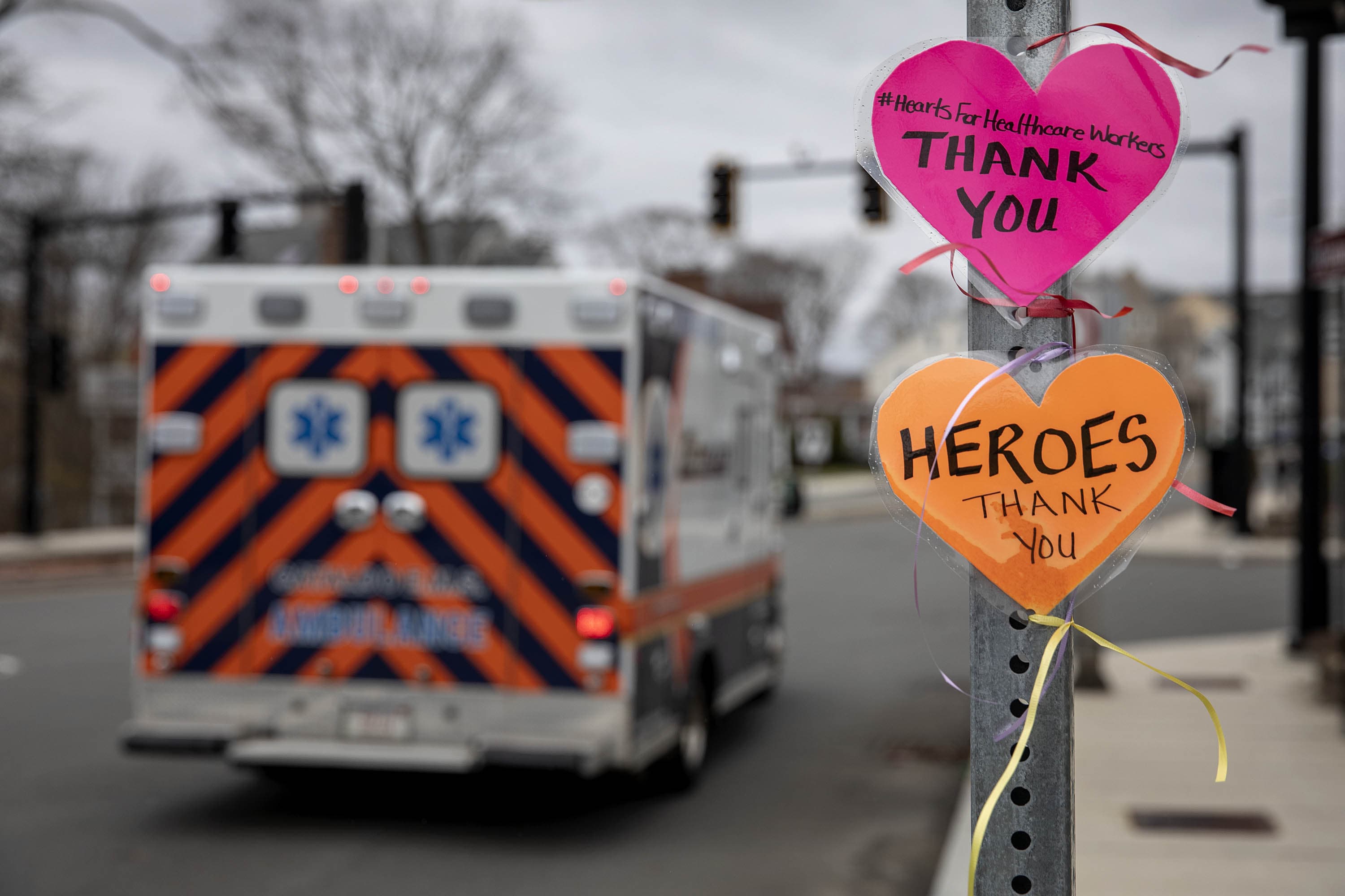 A message left on a street signpost by the Melrose Wakefield Hospital with the hashtag #HeartsForHealthcareWorkers, says "Thank you." (Robin Lubbock/WBUR)