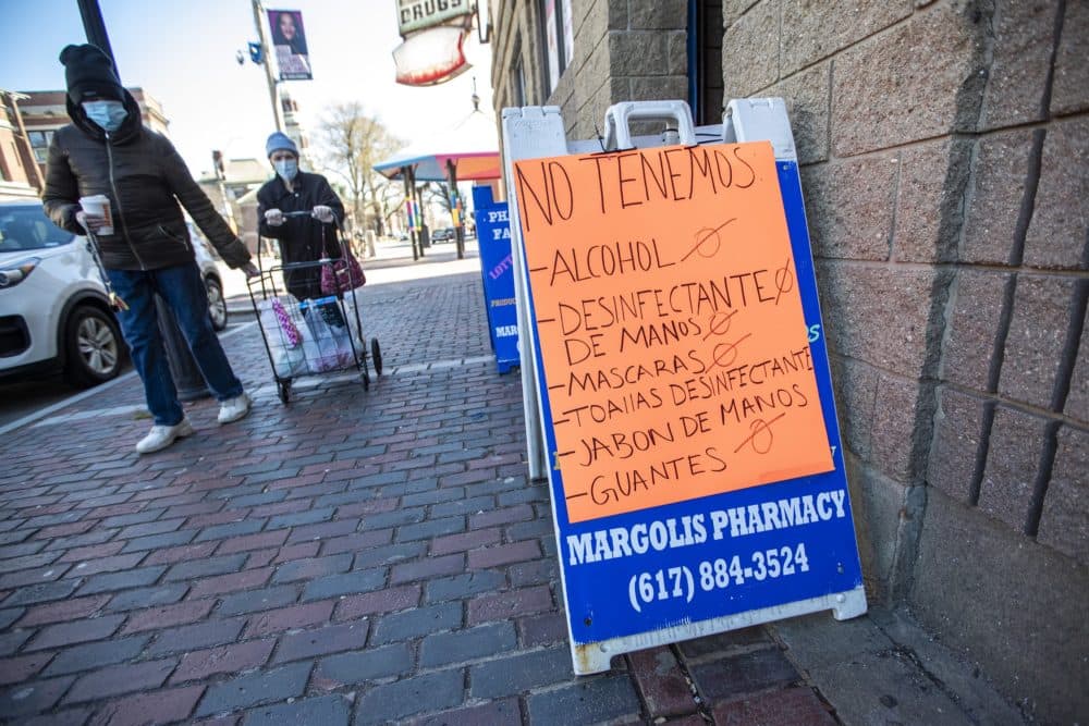 A sign at Margolis Pharmacy in Chelsea indicates in Spanish that they do not have many of the items necessary for people to combat the COVID-19 pandemic. (Jesse Costa/WBUR)