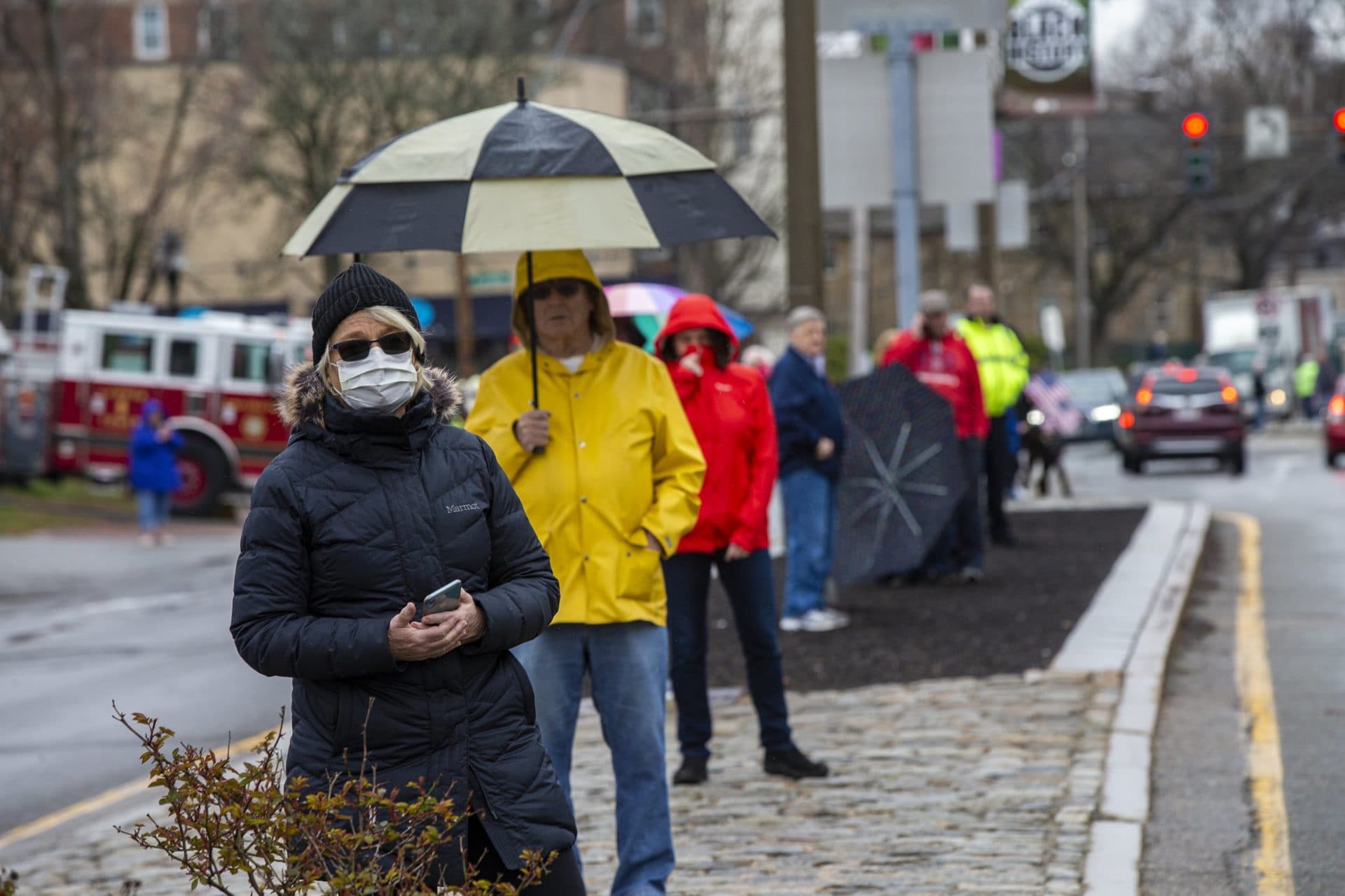 People lined the walkways of Mass. Ave. in Arlington center to await the funeral procession for Mary Foley. (Jesse Costa/WBUR)
