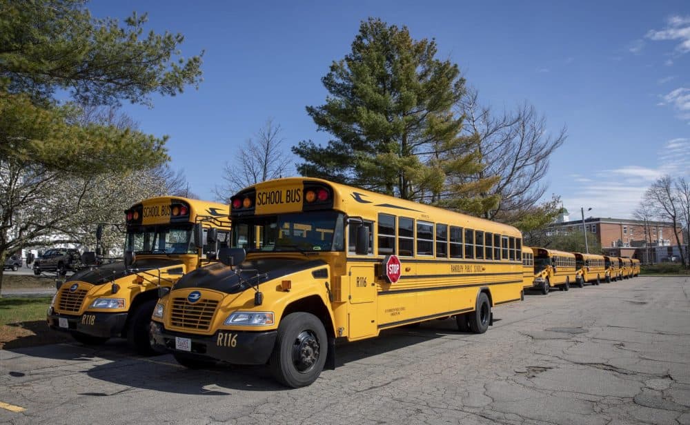 Randolph High School buses parked behind the school while the school is closed due to the COVID-19 epidemic. (Robin Lubbock/WBUR)